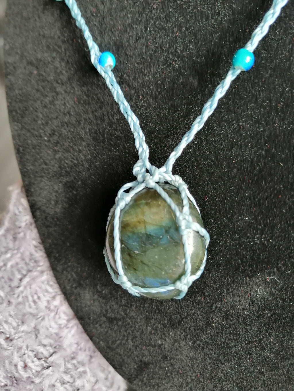 sautoir tissé a la main en micro macramé de couleur bleu ciel avec des perles en verre , des perles réfléchissante et une pierre en labradorite.