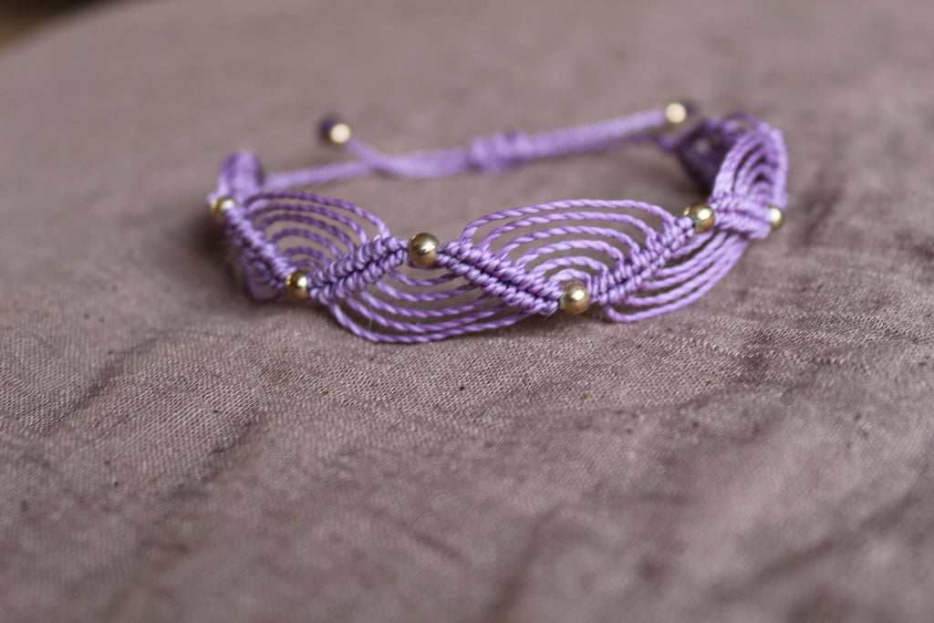 bracelet tissé à la main en micro macramé de couleur mauve avec des perles doré